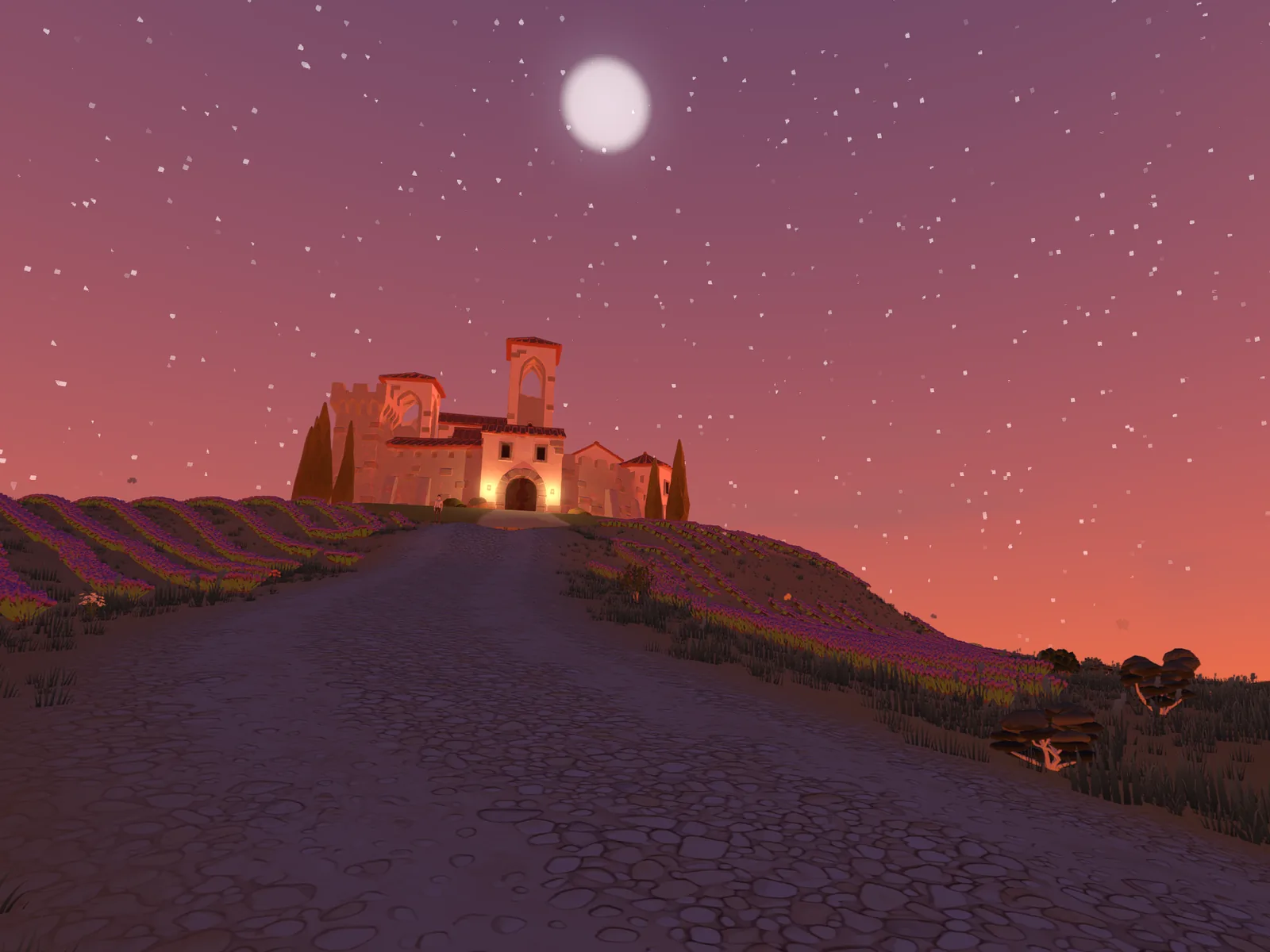 Le château illuminé sur sa colline au crépuscule, une route qui y monte